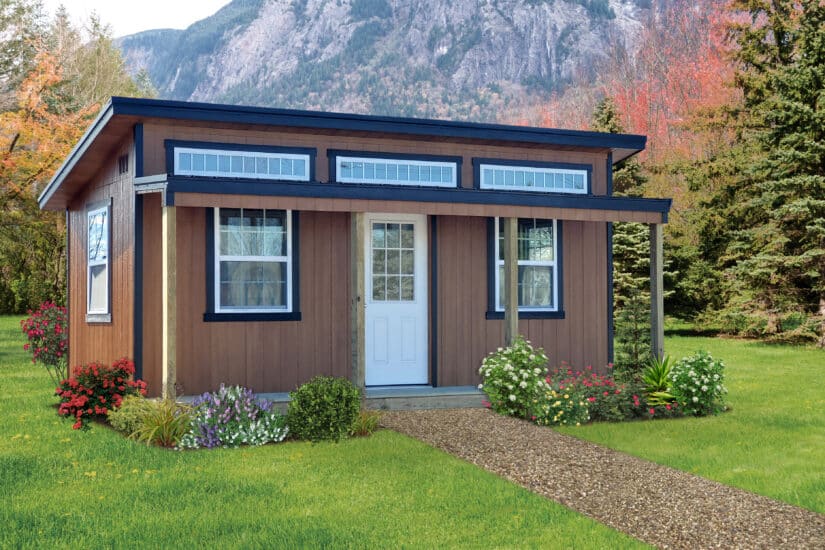 Studio shed with transom windows in a backyard.